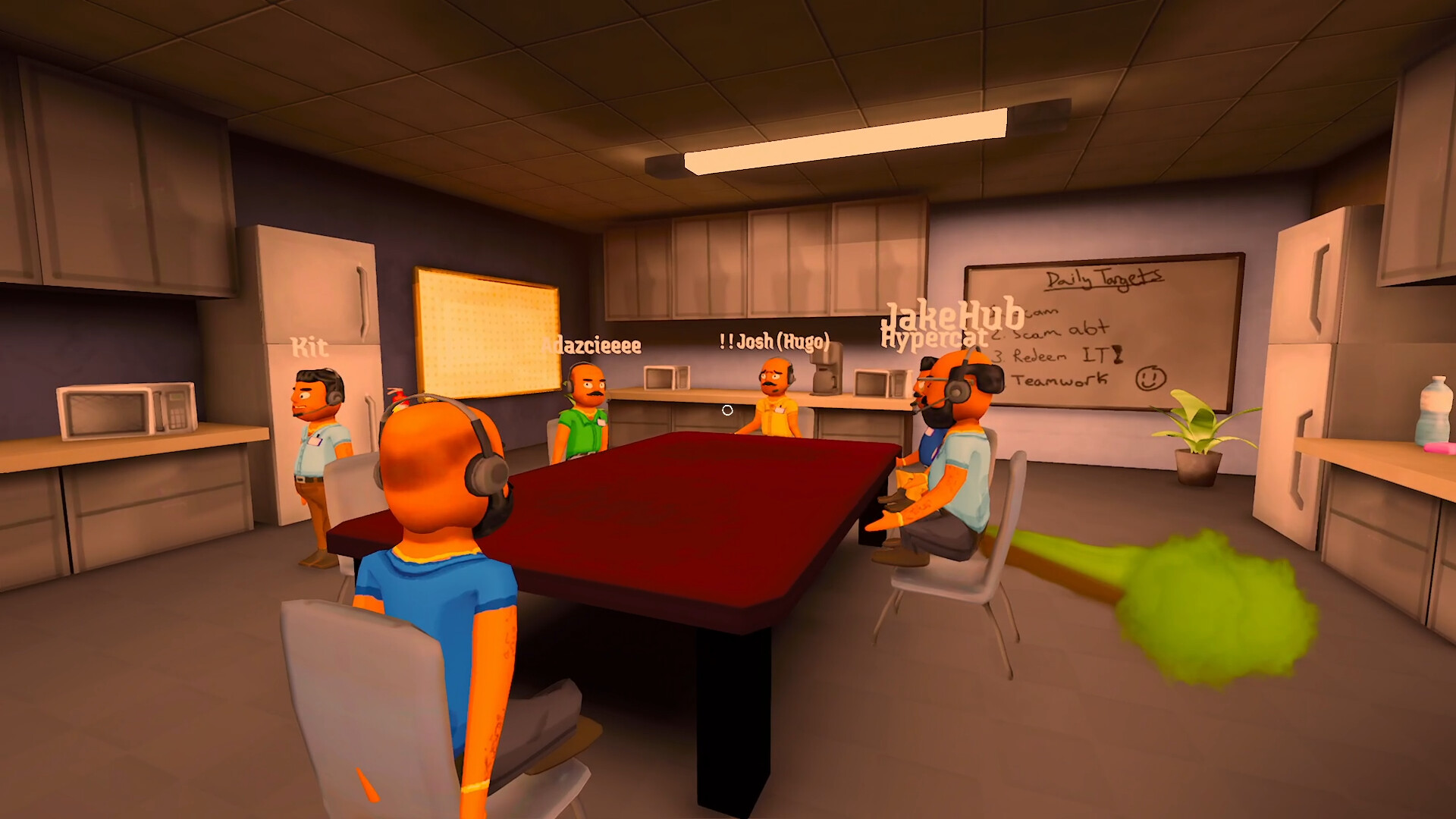 Several coworkers gather around a table in the call-center office.
